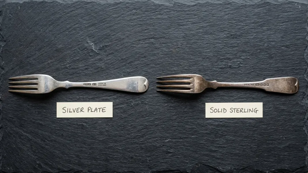 EPNS silverplate fork next to solid .925 sterling silver fork with hallmarks visible on both handles